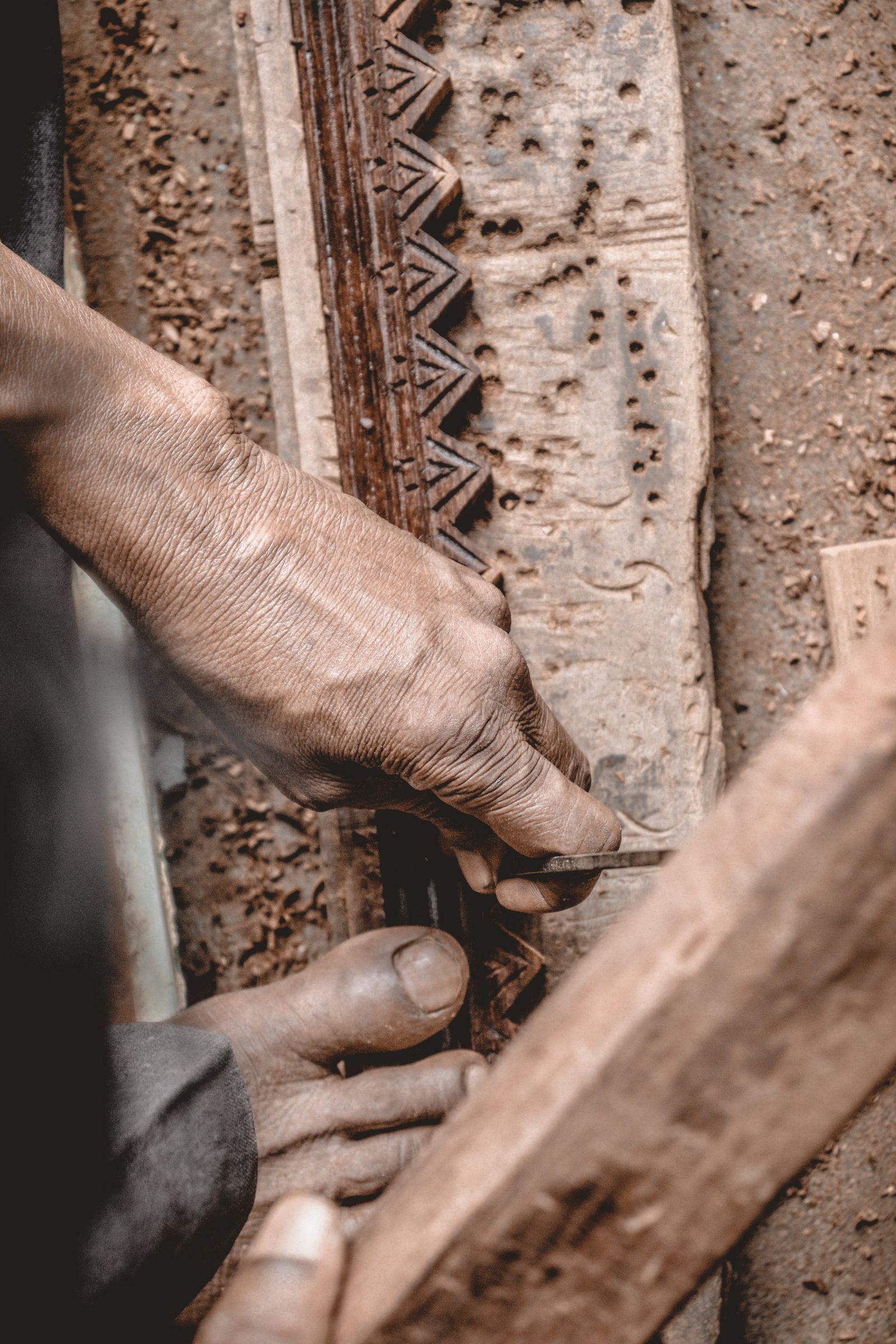 Hands carving a small wooden project